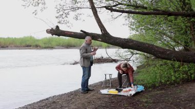 Bir erkek ve bir kadın doğada piknik yaptılar. Doğada aktif eğlence..