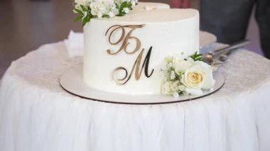 Gelin ve damat tarafından kesilen güzel düğün pastası. Düğün gelenekleri..