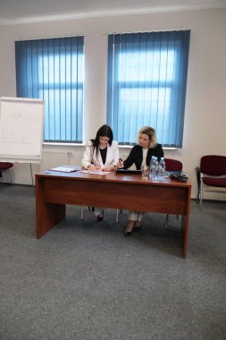 İki kadın bir projeyi görüşmek ve kontrat imzalamak için buluşuyor..