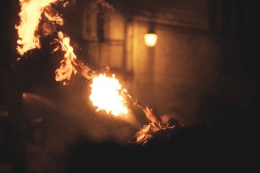 Impressive fireball coming out of the mouth of a fire-eater during a medieval festival in Monpazier, Dordogne - France