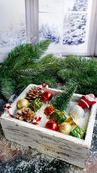 stock image Christmas and New Year. Festive background with fir branches, Christmas tree, Christmas toys in a box and on the snow. copy space