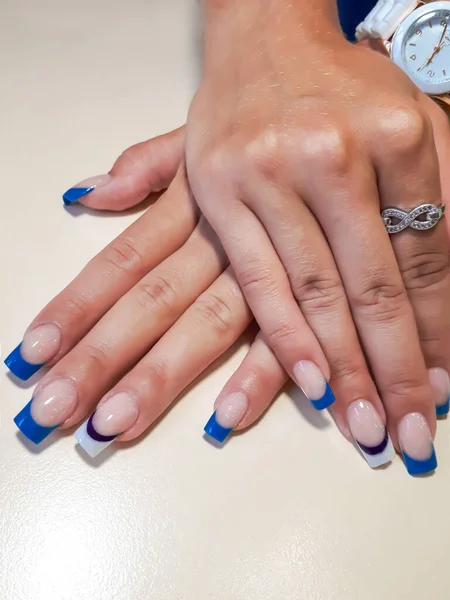 Acrylic nail extension, manicure, nail correction, hands in the foreground. Reflective design. copy space