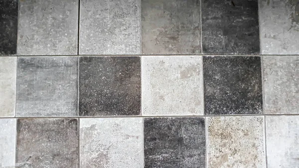 Stock image Stone background made of laminate. Square tiles in grey. Placed on the floor. copy space