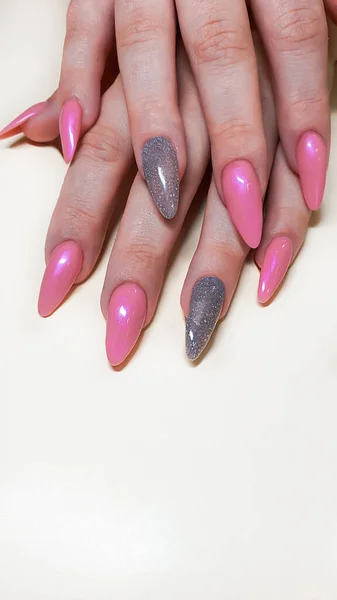 Acrylic nail extension, manicure, nail correction, hands in the foreground. Bright design. copy space