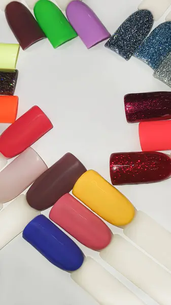 Palette of multi-colored nail polishes. Manicure and gel polish color choice. Copy space.