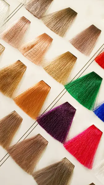 A palette of hair colors made from artificial strands on a white background. Color selection. Copy space