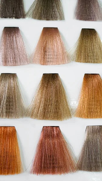 A palette of hair colors made from artificial strands on a white background. Color selection. Copy space