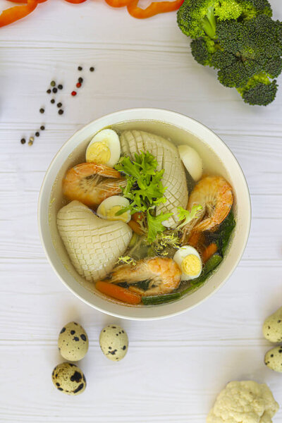 Seafood soup with squid, shrimp and boiled egg. Diet food. Copy space