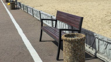 Ahşap banklar ve çöp kutuları yolun kenarında park dinlenme alanında. Yaz