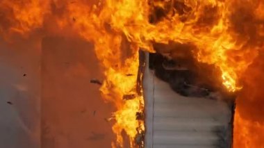 Close up detailed shot of flames engulfing a building. Slow motion footage of fire, embers, and ash debris. High quality FullHD footage. Slow motion.