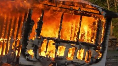 Trailer home on fire. Slow motion. Large house fire ablaze with large flames and smoke. High quality FullHD footage. Slow motion.