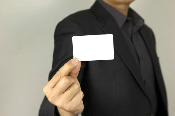 Business Man holding white ID card, A smart man holding white mock up inter card, used for poster concept designs.