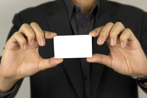 A man\'s hand holding white card for inter card concept design, and smart dart man showing white mock up ID card on white background.