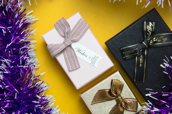 Set Three Gift Boxes Purple Ribbons Yellow Background Xmas New — Stock Photo, Image