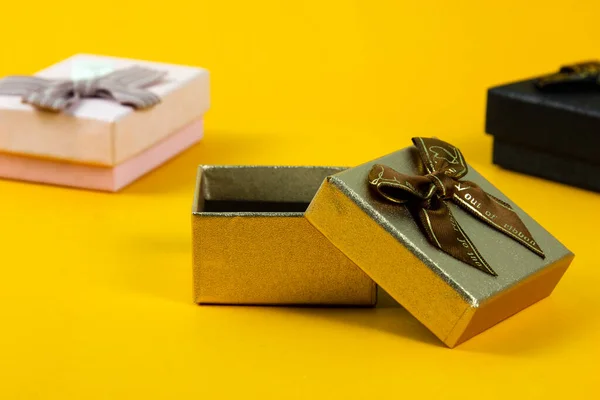 stock image Group of Gift Boxes for close up view with yellow background, and One Gift box opened for promotion artwork design.