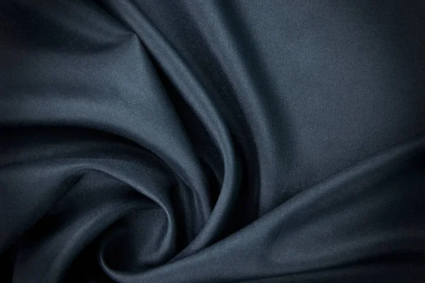A dark blue fabric, clothes textile, wallpaper, fashion concepts of silk and cottons, Texture, background. template. Silk fabric blue, Blue silk drapery and upholstery fabric.