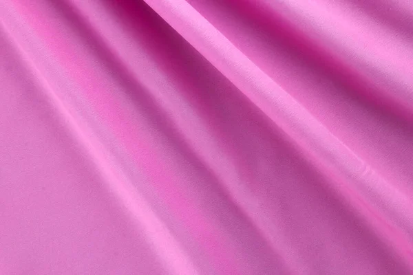Beautiful pink fabric and cotton cloth textile background, wavy pink cotton, smooth premium pink fabric clothes background, close up on top view.