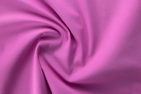 Close-up pink cloth texture of natural fabric, a pink fabric cloth. wavy Fabric texture of natural cotton material canvas background. on top view.