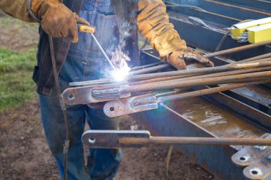 Welding Work. Metal Welding. During Production, a Welder Welds Metal Products Together