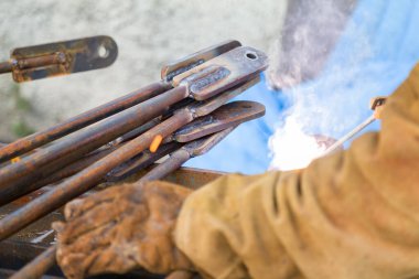 Welding Work. Metal Welding. Metal Products are Welded by a Welder in Production