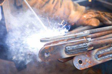 Welding Work. Metal Welding. The Welder in a Production Setting Welds Metal Products Together