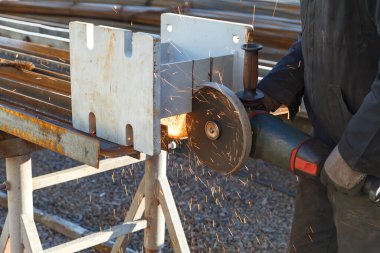 Cutting steel. Sparks during cutting of iron. Man cuts metal product