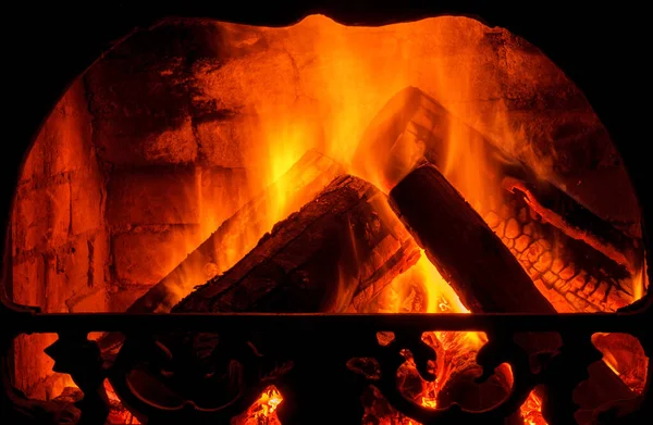 Wood burning in fireplace. Fire keep warm. Crest of flame on burning wood in fireplace
