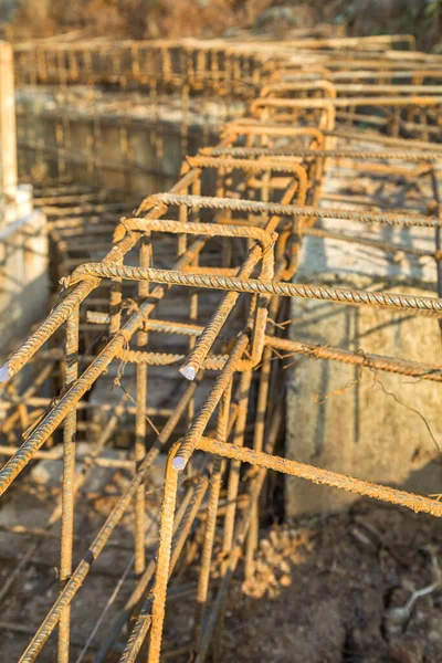 Reinforcing concrete blocks on the construction site with metal reinforcement. Adding metal reinforcement to concrete blocks during construction
