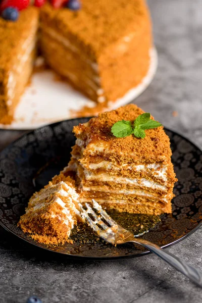 Honey cake. Homemade baking concept. Slit and slice of cake. Homemade layered honey cake