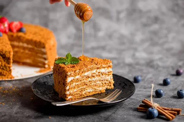 Honey cake. Homemade baking concept. Slit and slice of cake. Homemade layered honey cake