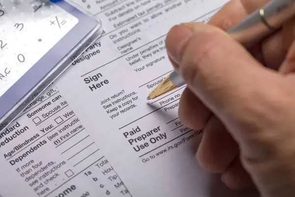 Income tax with instruction. Tax payment and filing concept. 2022 tax return form 1040 with calculator. The concept of filing a tax return