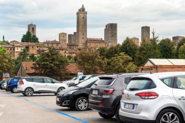 SAN GIMIGNANO, İTALYA - 17 Eylül 2018: Bu ünlü ortaçağ kasabasının duvarlarının yanında modern bir araba parkı.