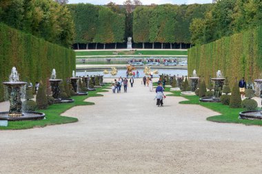 VERSAILLES, FRANCE - SEPTEMBER 8, 2019: This is an alley with fountains to the Dragon Pool in the palace park.