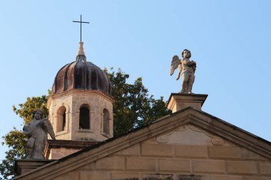 ZADAR, CROATIA - SEPTEMBER 14, 2016: These are cherubs on the pediment of the church of the Virgin of Health and the top of the church bell tower.