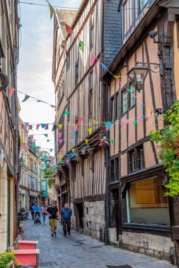 ROUEN, FRANCE - AUGUST 31, 2019: This is one of the narrow streets of the medieval part of the city, built up with half-timbered houses, in the evening