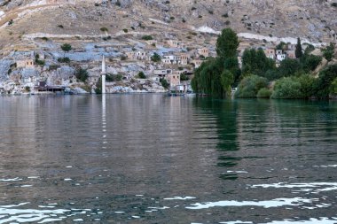 HALFETY, TURKEY - OCTOBER 6, 2020: This is the old city with the minaret of the mosque, flooded by a modern reservoir on the Euphrates River.