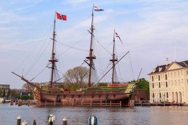 AMSTERDAM, NETHERLANDS - MAY 6, 2013: This is ship 'Amsterdam' and the building of the Dutch National Maritime Museum.Netherlands.