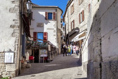 SAN MARINO, SAN MARINO - MARTH 11, 2023: Bir grup kimliği belirsiz turist bağımsız İtalyan enklavı devletinin başkentinin eski ortaçağ sokaklarını keşfediyor.