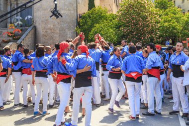 GIRONA, SPAIN - MAY 14, 2017: A team of unidentified castelliers prepares for the traditional show during the Festival of Flowers.