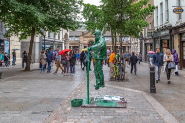 LONDON, GREAT BRITAIN - MAY 23, 2014: This is a performance by an unidentified street performer outside Covent Garden Market.