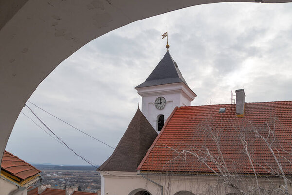 MUKACHEVO, UKRAINE - MARTH 5, 2023: This is a view from the gallery of the Upper Courtyard of Palanok Castle to the Clock Tower.