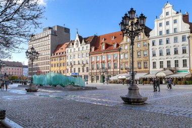WROCLAW, POLAND - 4 Kasım 2023 Burası tarihi binaların ve bir sonbahar sabahı çeşmesinin olduğu Pazar Meydanı.