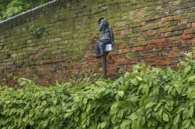 MELK, AUSTRIA - MAY 12, 2019: This is a funny decorative figurine of a crow near the fence of the monastery park.