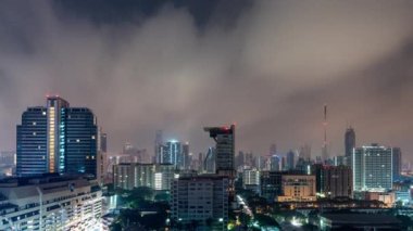 Bangkok, Thailand - 13 January 2023 - Time lapse view of Bangkok high-rises at night with moving clouds in the sky 