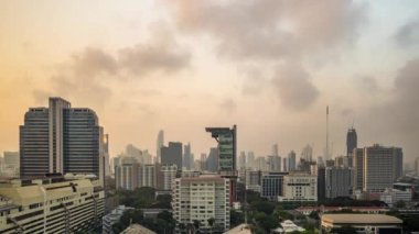 Bangkok, Thailand - 13 January 2023 - Time lapse view of Bangkok high-rises  during sunset with moving clouds in the sky