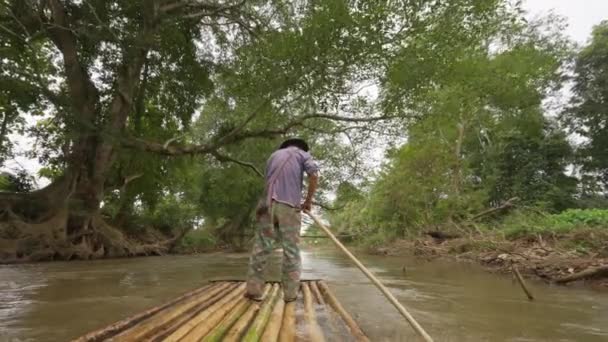 2022年12月5日 チェンマイ 竹製の筏で地元の男性の背中に長い竹の棒を使用して チエンダオ チェンマイ タイの小さな川を彼のいかだをプッシュします — ストック動画