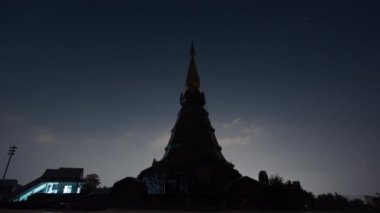 Chiang Mai, Thailand - 25 February 2023 - Time lapse night view of moving stars at the famous Phra Mahathat Noppamethanedon and Nopphonphusiri monuments up on Doi Inthanon, Thailand's tallest mountain