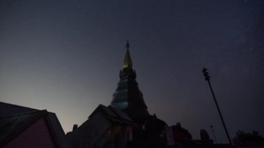 Chiang Mai, Thailand - 25 February 2023 - Time lapse night view of moving stars at the famous Phra Mahathat Noppamethanedon and Nopphonphusiri monuments up on Doi Inthanon, Thailand's tallest mountain