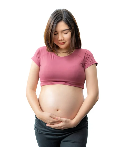 幸せな笑顔アジアの妊娠中の女性でフィットネス服立って彼女の腹に白い背景 コピースペースのための部屋 — ストック写真