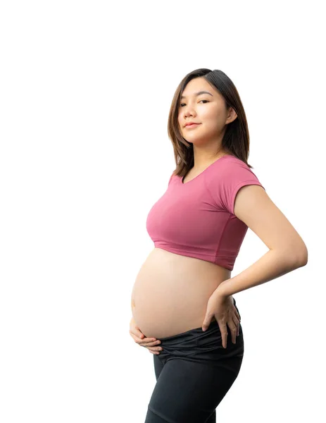 幸せな笑顔アジアの妊娠中の女性のプロフィールでフィットネス服を身に着けています彼女の腹白い背景に対して コピースペースのための部屋 — ストック写真